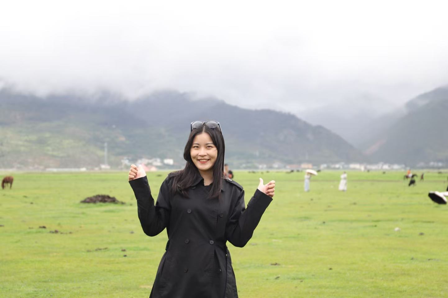 Lehan Xiao in a green mountain landscape